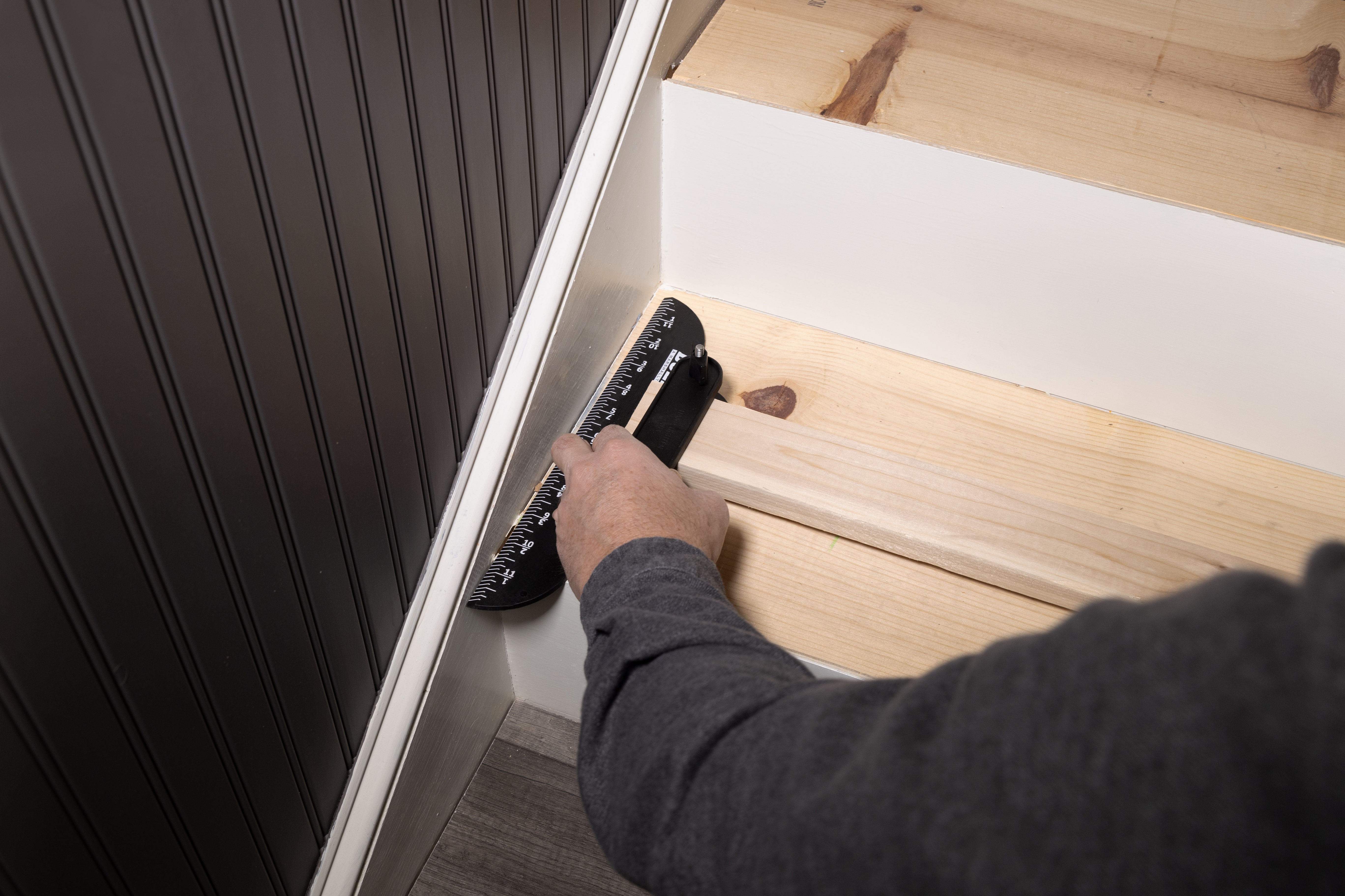 lining up the stair tread tool at the corner and edge